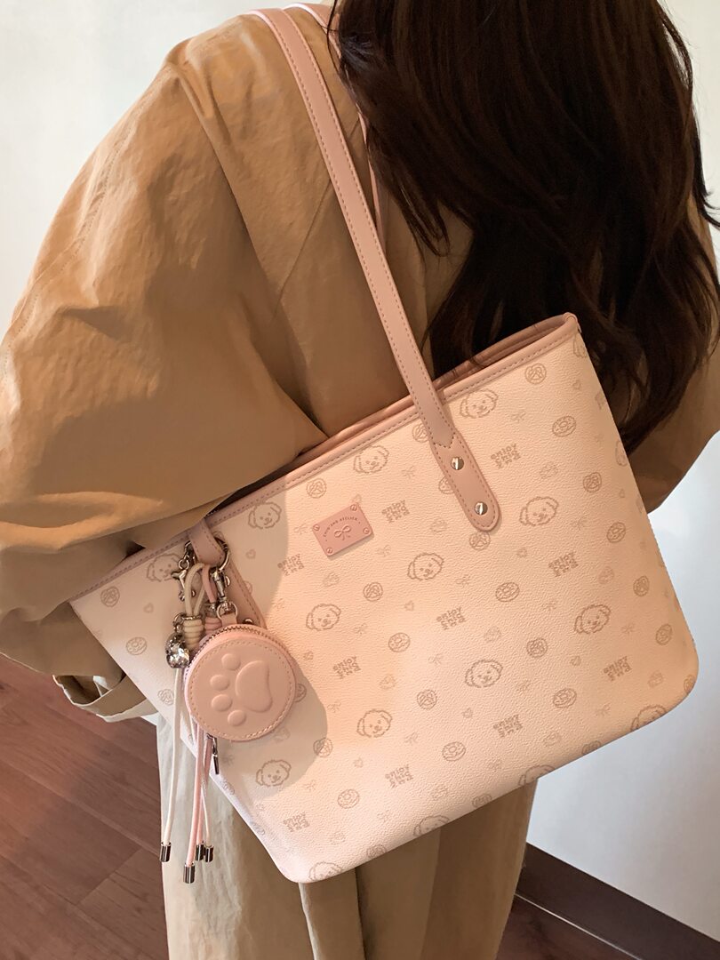 Light pink patterned shoulder tote bag worn by a model