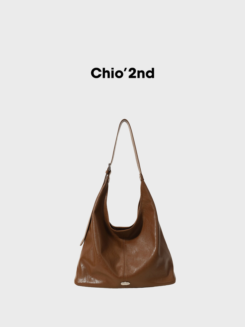 Brown leather shoulder bag on a plain background