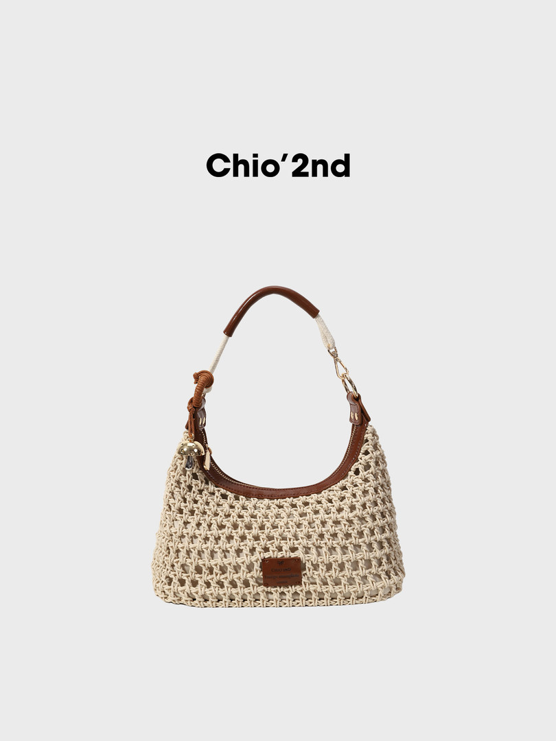 Cream woven shoulder handbag with brown leather trim on a white background