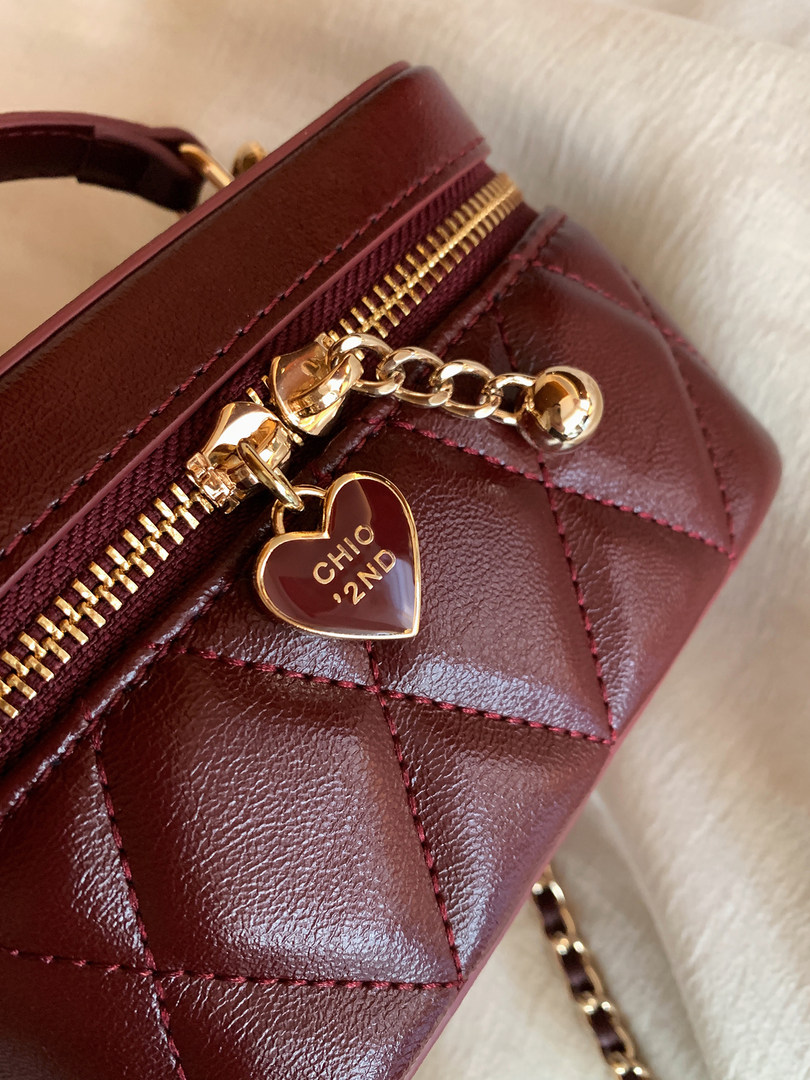 Burgundy quilted leather handbag with gold zipper and heart charm