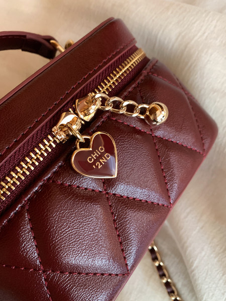 Burgundy quilted leather handbag with gold zipper and heart charm