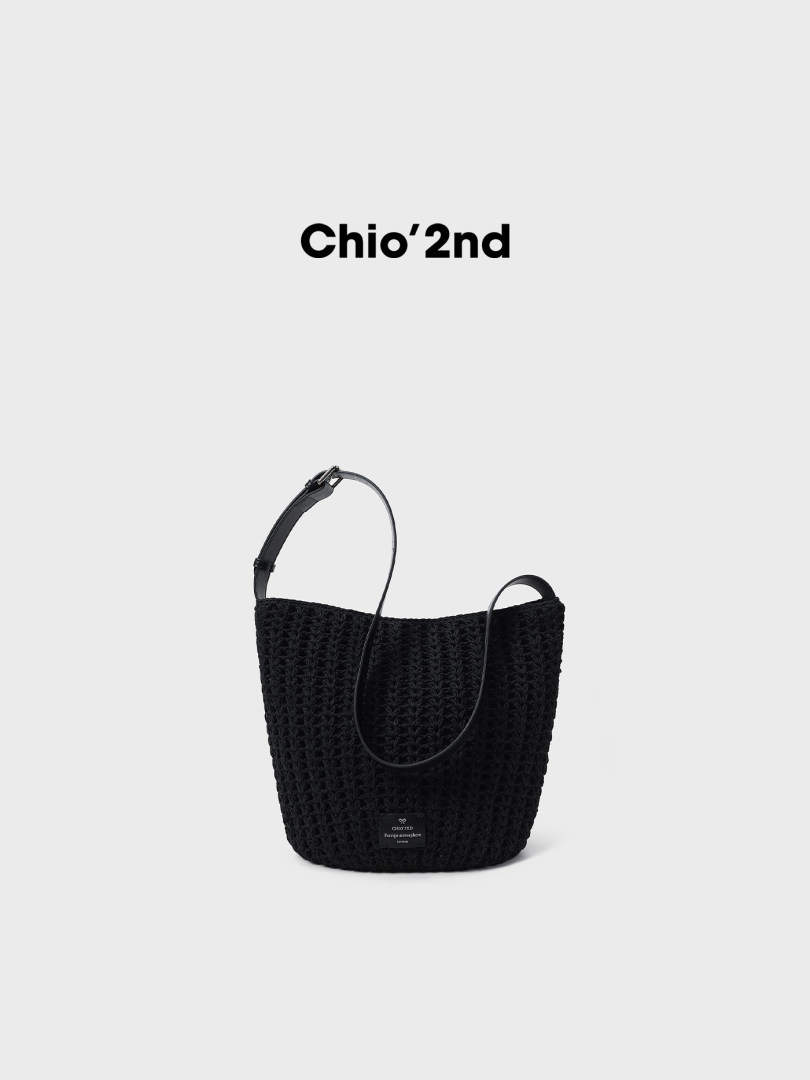 Black woven shoulder tote bag on a white background