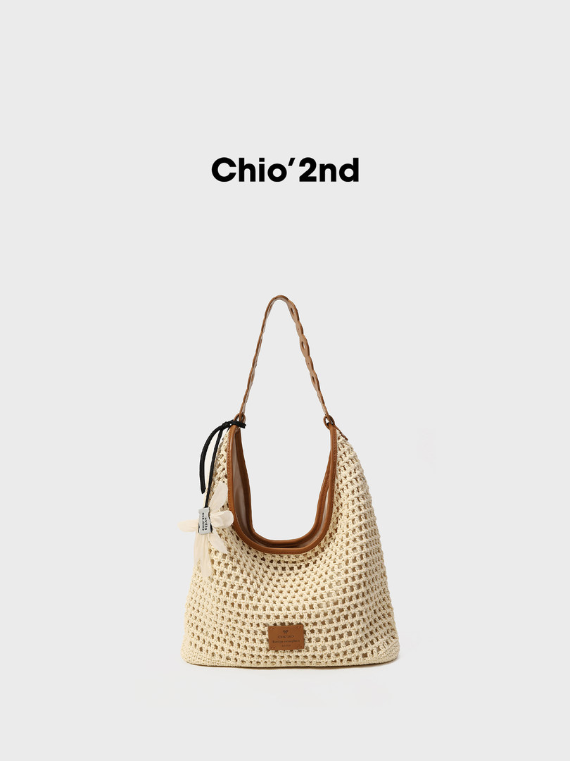 Cream crochet tote bag with brown trim and shoulder strap on white background