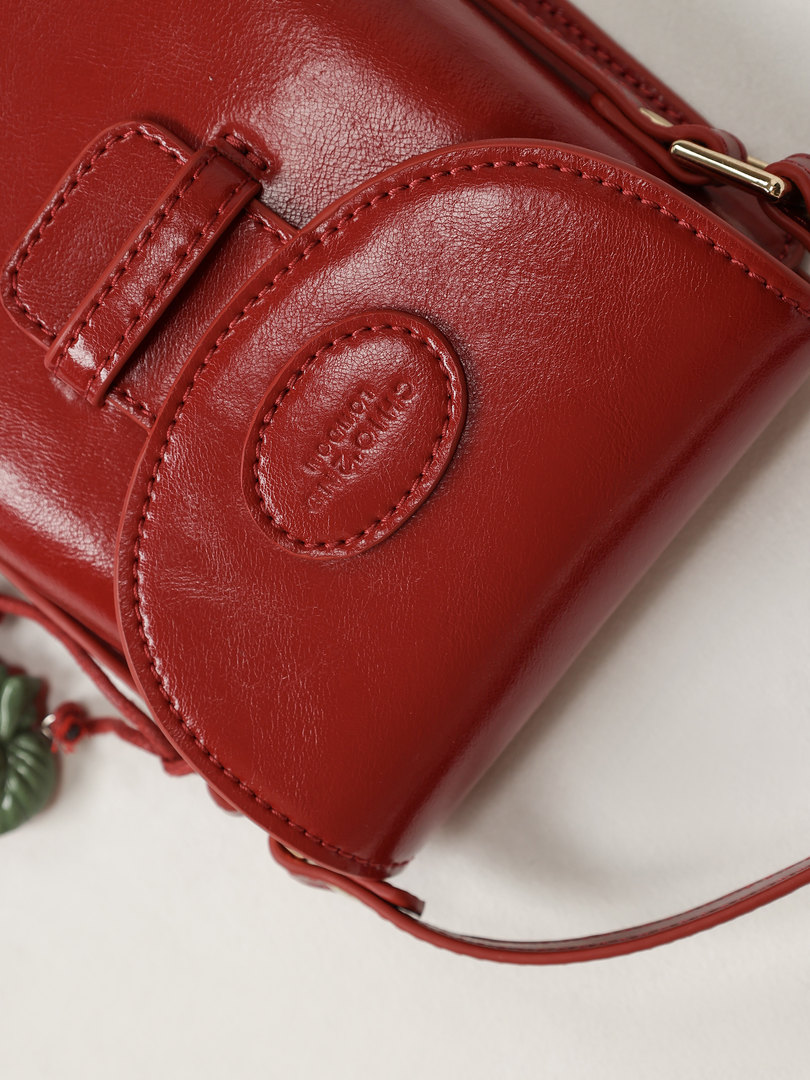 Red leather handbag with stitched detailing and gold hardware