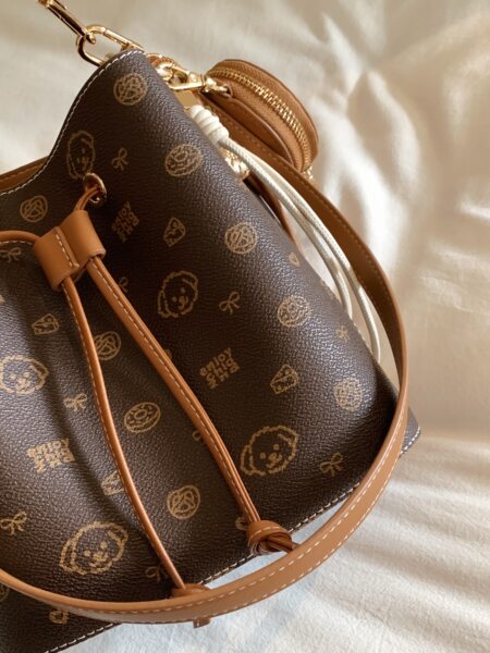 Brown monogram drawstring handbag with tan straps and gold hardware