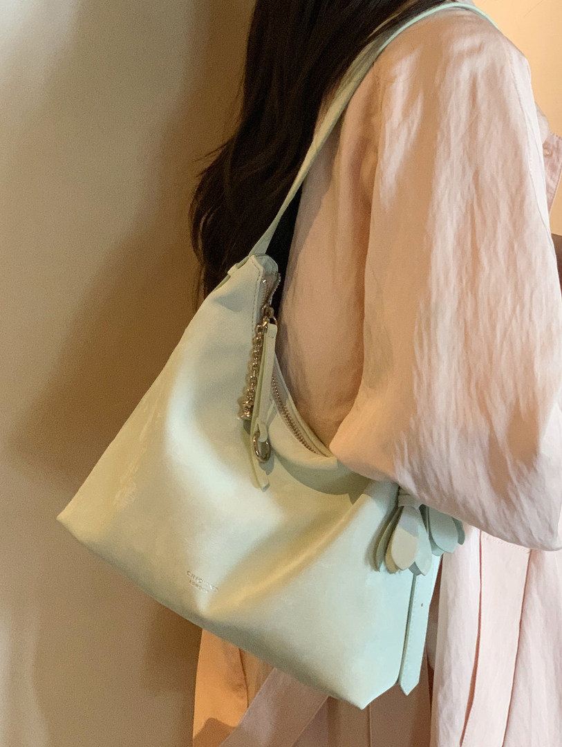 Light blue leather shoulder bag worn by a model