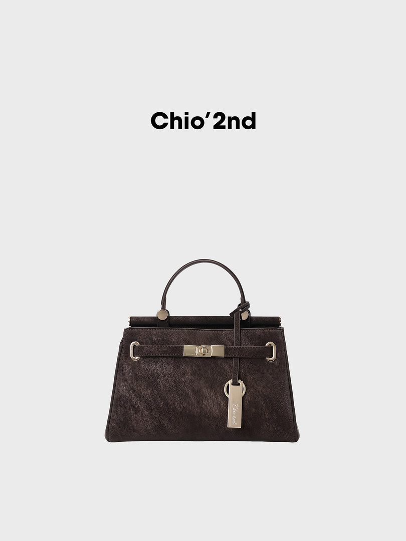 Dark brown leather handbag on a white background with brand text above