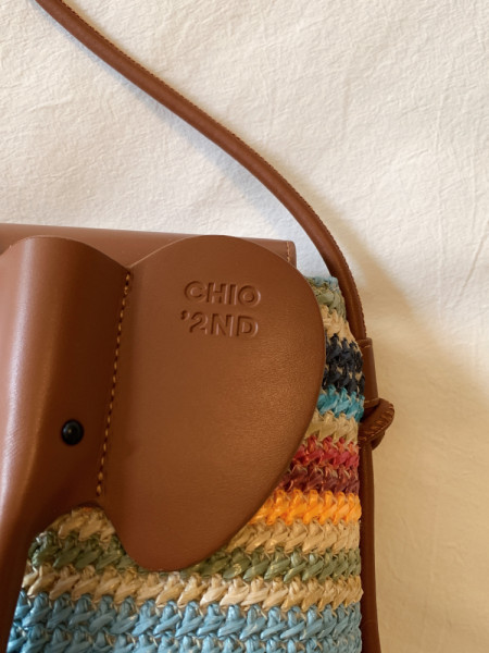 Multicolor woven handbag with brown leather flap and strap