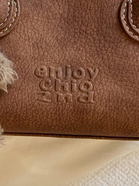 Close-up of a brown textured leather item with embossed text