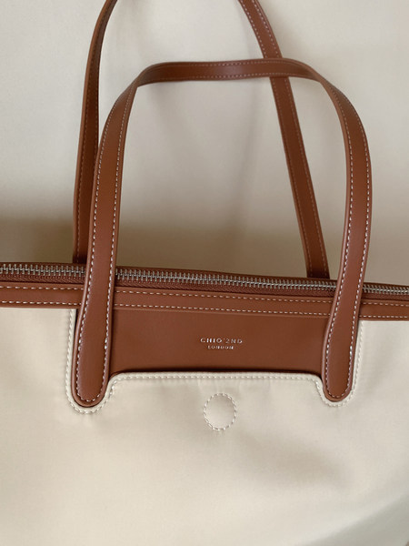 Brown and cream tote handbag with long handles and zip top
