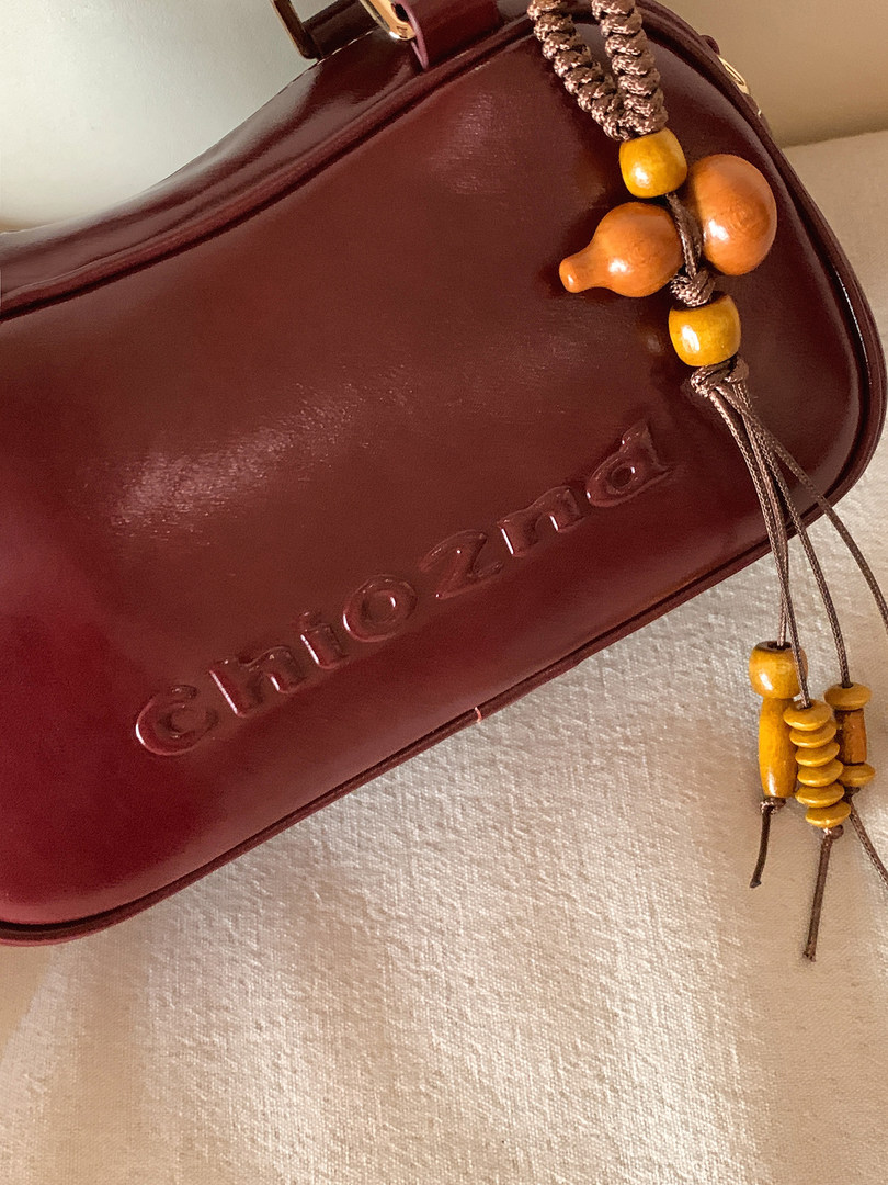 Brown leather handbag with beaded tassel detail