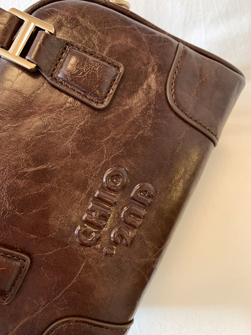 Brown leather boot with buckle detail shown in close-up