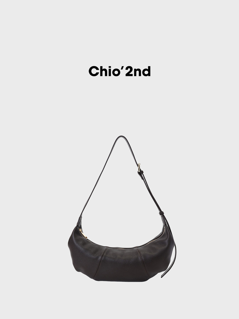 Black leather shoulder bag on a plain background with brand text above