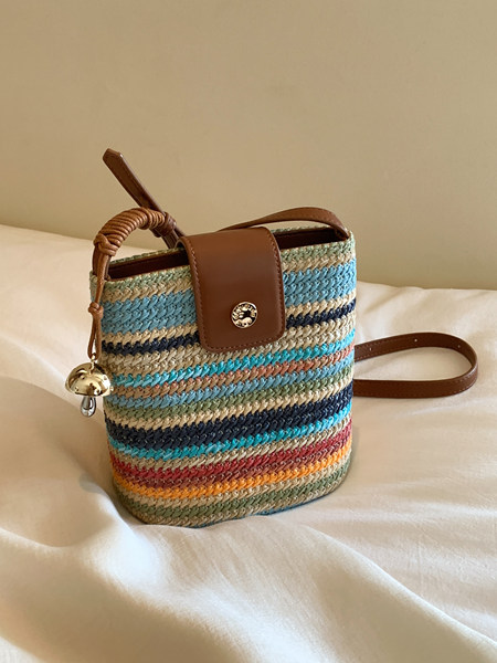 Multicolor woven straw handbag with brown leather trim and shoulder strap
