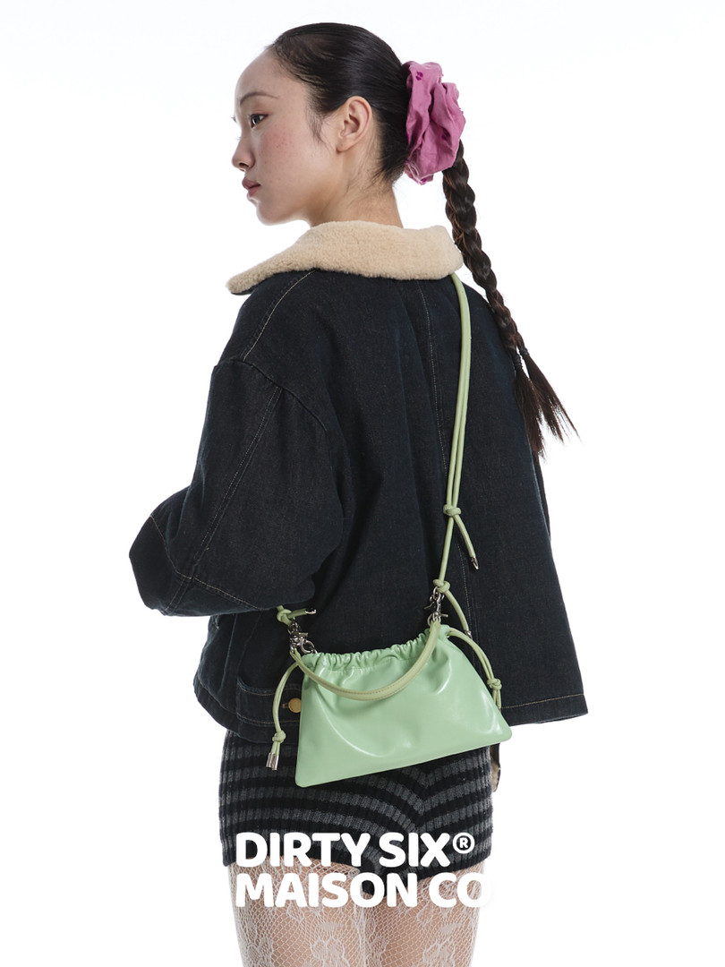 Mint green small shoulder bag worn by a model with a crossbody strap