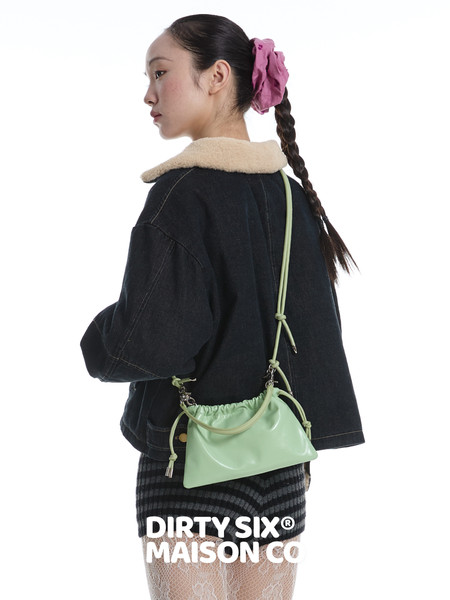 Mint green small shoulder bag worn by a model with a crossbody strap