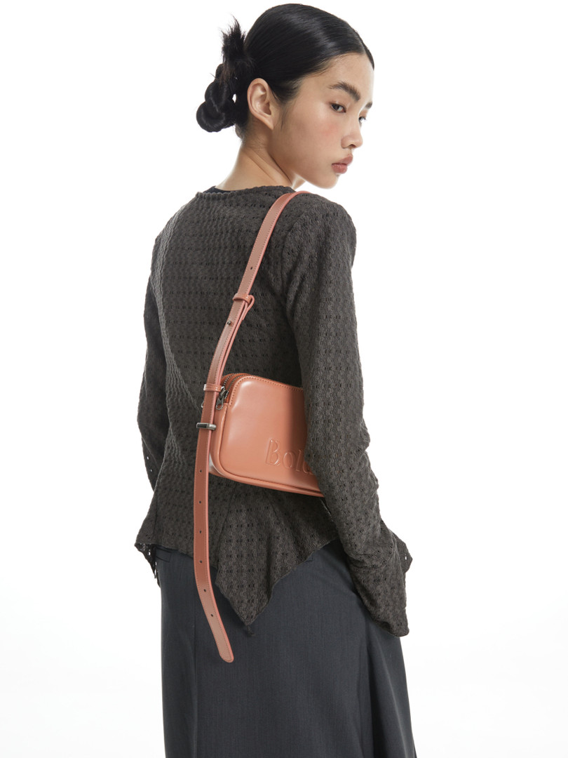 Crossbody leather handbag worn by a model