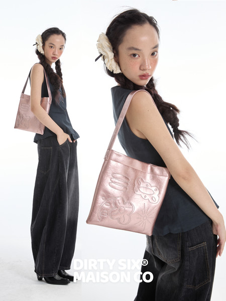 Pink shoulder tote bag worn by a model