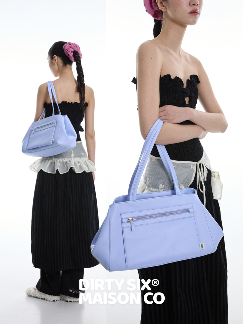 Light blue shoulder handbag worn by a model in a fashion photo