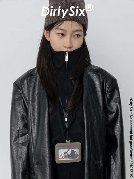 Model wearing a black leather jacket and beanie with brand text overlay