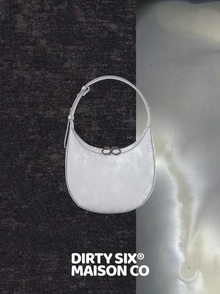White shoulder handbag with a curved strap on a two-tone background