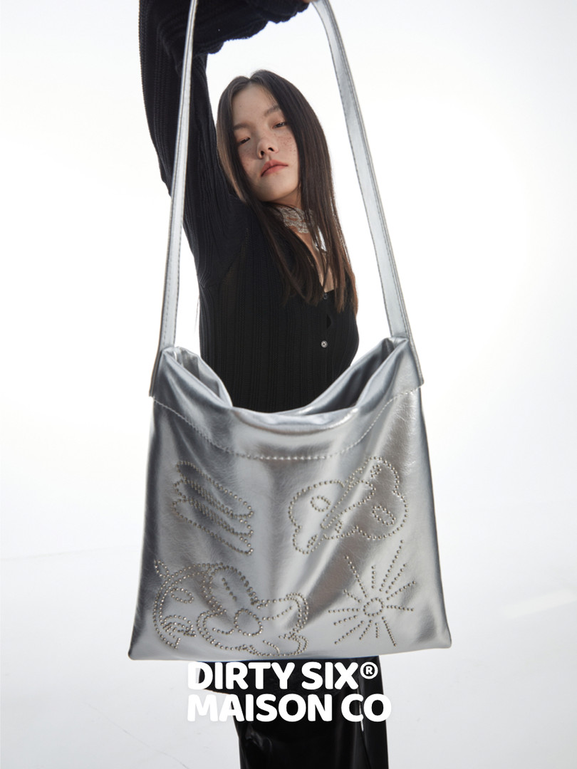 Silver metallic shoulder bag worn by a model