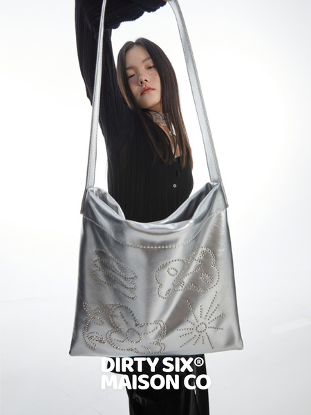 Silver metallic shoulder bag worn by a model