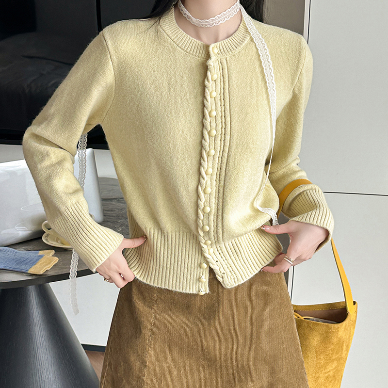 洋气扭扭排扣开衫毛衣女2025年秋冬新款设计感镂空针织衫长袖上衣