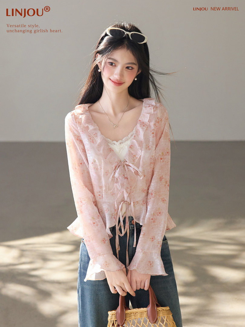 Model wearing a pink floral sheer tie-front blouse with long sleeves