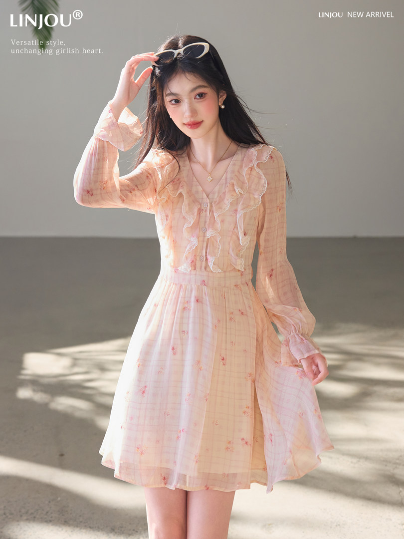 Model wearing a pastel pink floral ruffle dress