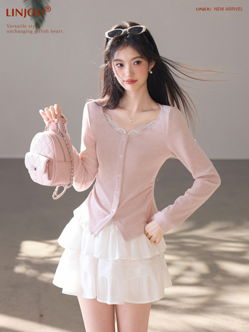 Model wearing a light pink cardigan and white skirt holding a quilted pink mini backpack.