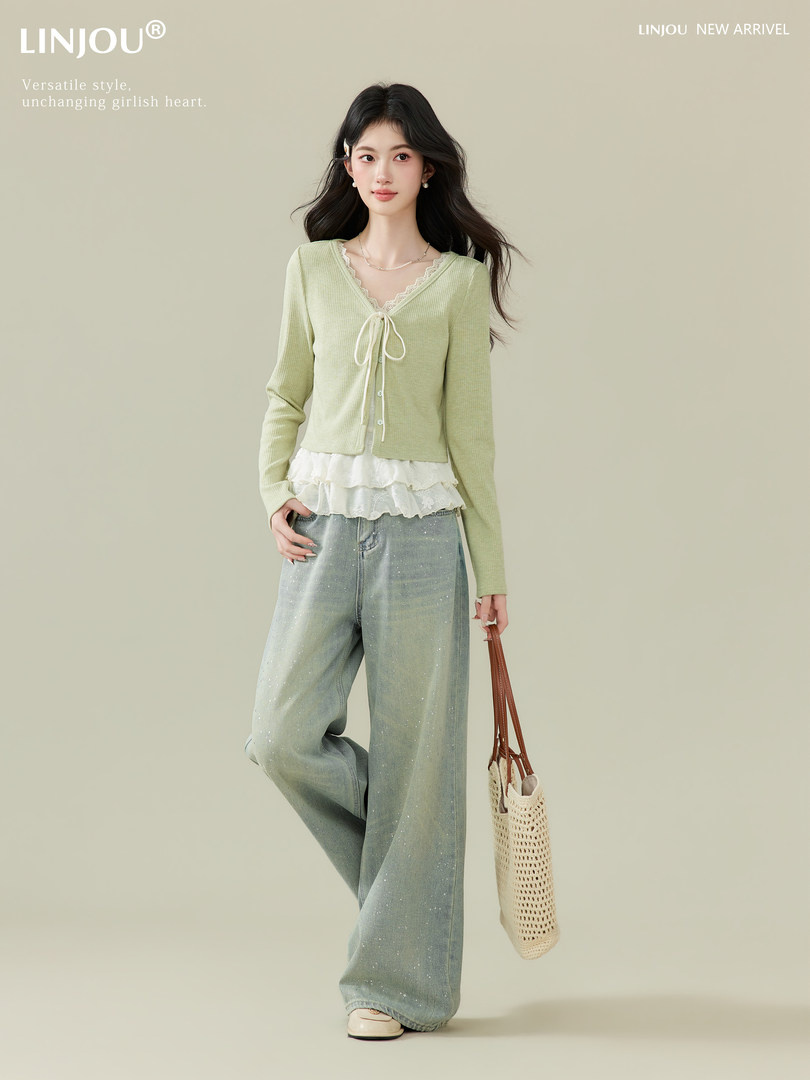 Model wearing a light green cardigan top with wide-leg jeans and a woven tote bag