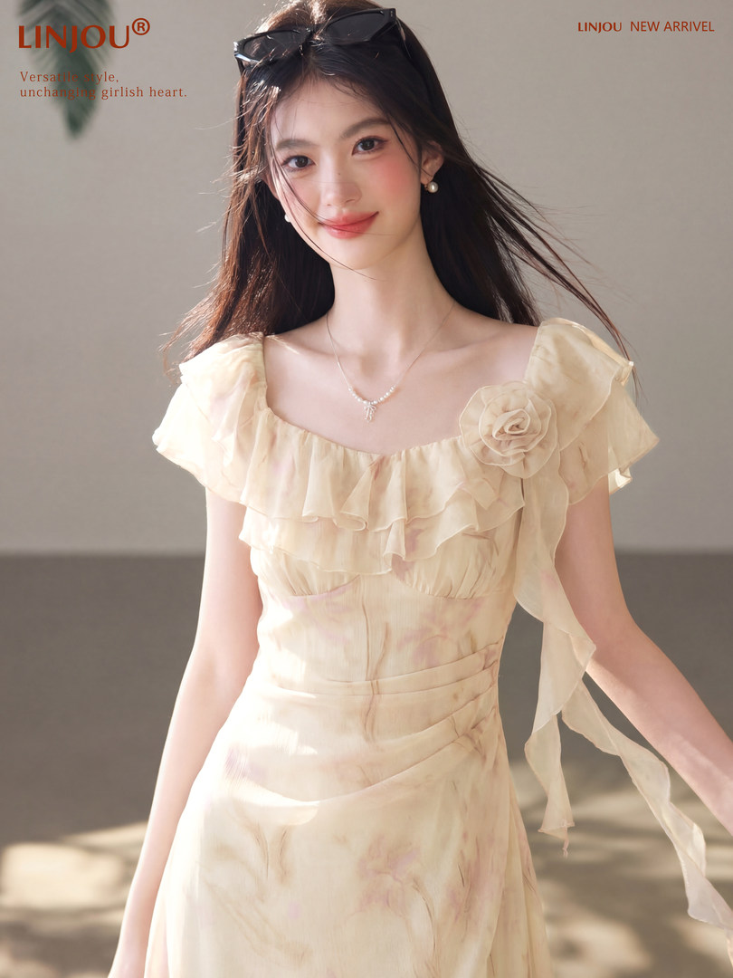 Model wearing a cream ruffled floral dress