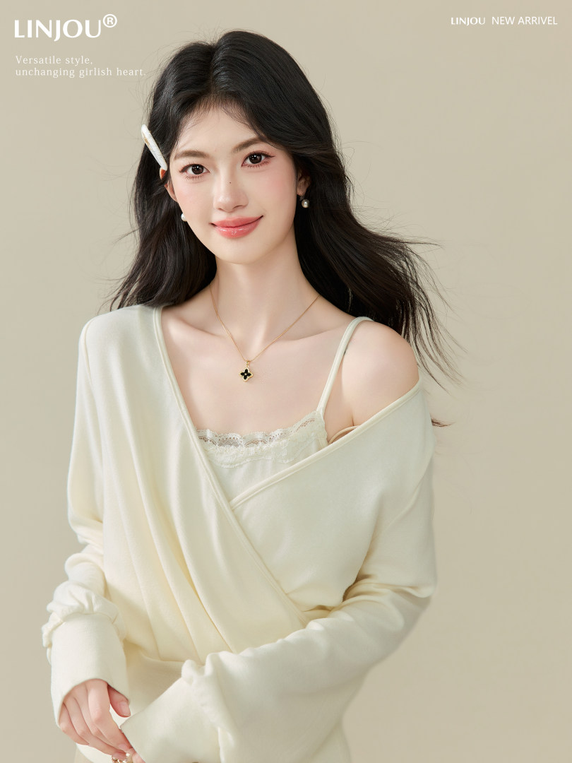 Model wearing a cream off-shoulder wrap top with lace camisole underneath