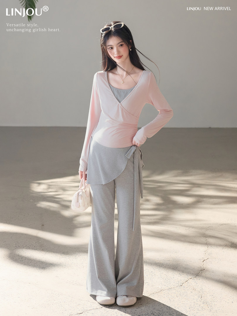 Model wearing a pink-and-gray loungewear set with wide-leg pants