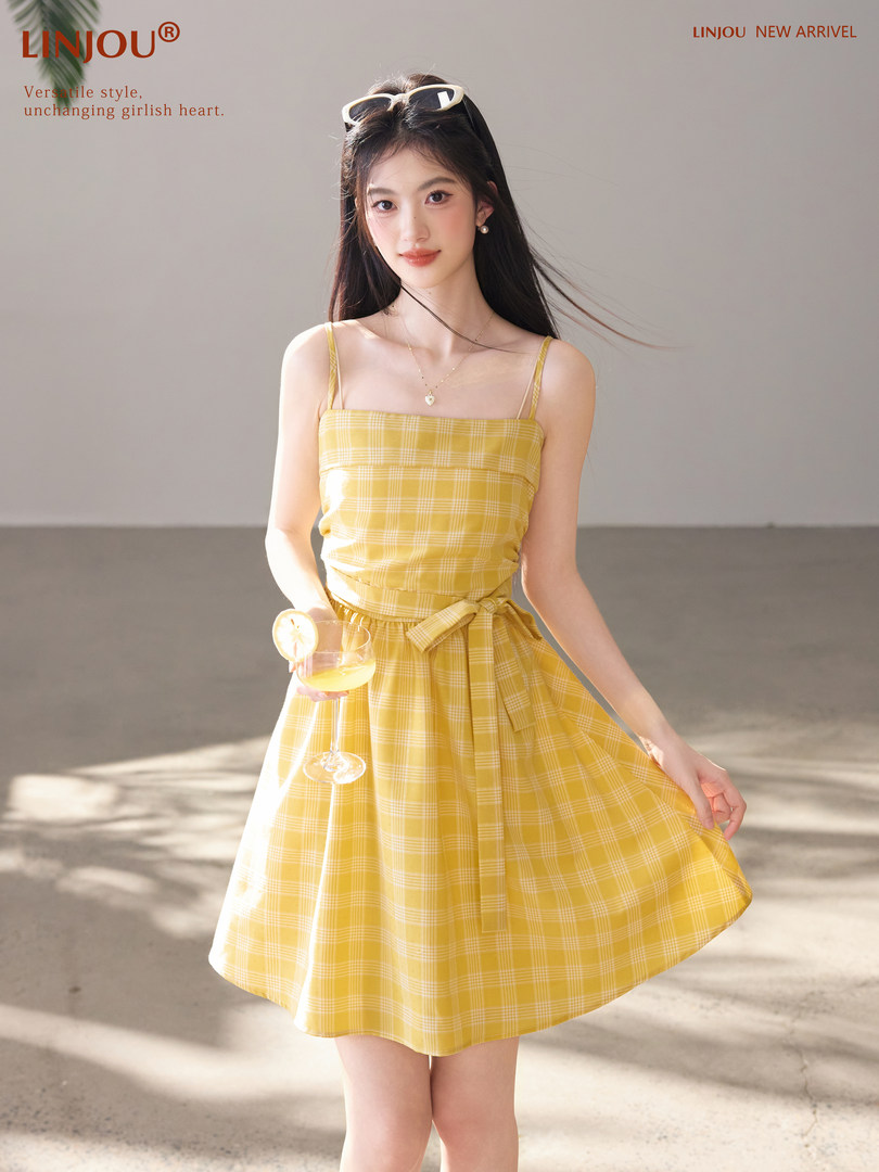 Model wearing a yellow plaid sleeveless dress