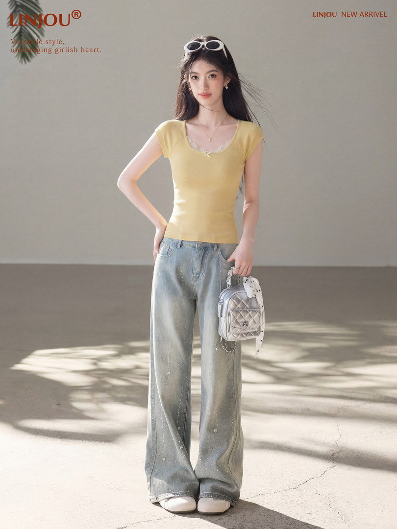 Model wearing a yellow fitted short-sleeve top with wide-leg jeans and a small handbag