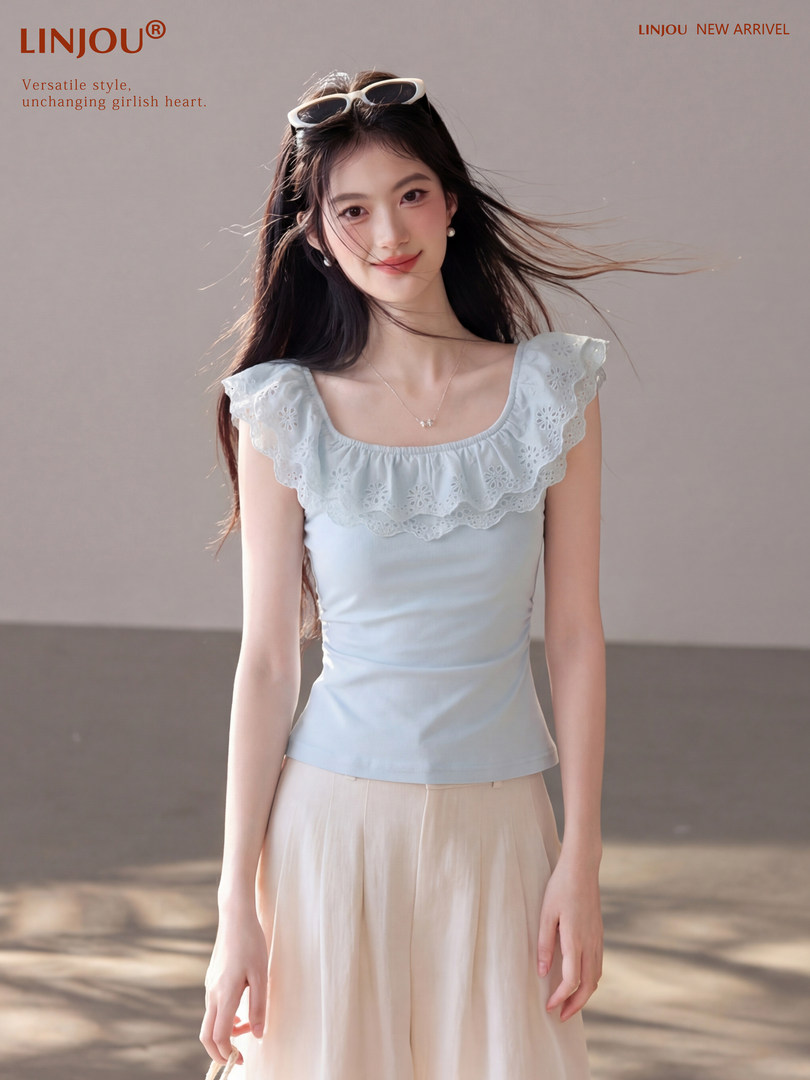Model wearing a light blue sleeveless ruffled top with a pastel skirt