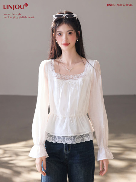 White sheer long-sleeve lace-trim blouse worn with dark jeans