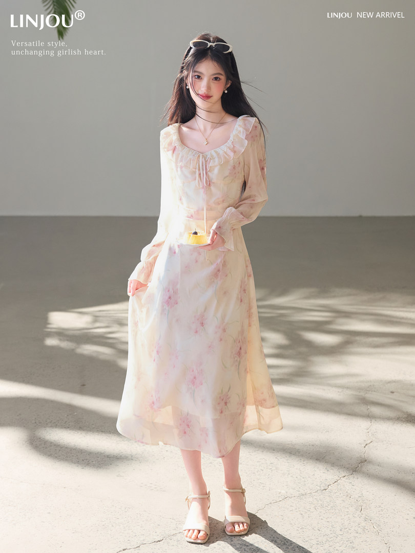 Model wearing a light floral long-sleeve midi dress