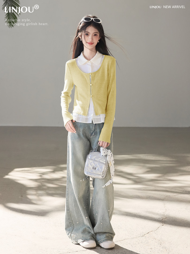 Model wearing a yellow cardigan over a white blouse with wide-leg jeans and a small silver backpack