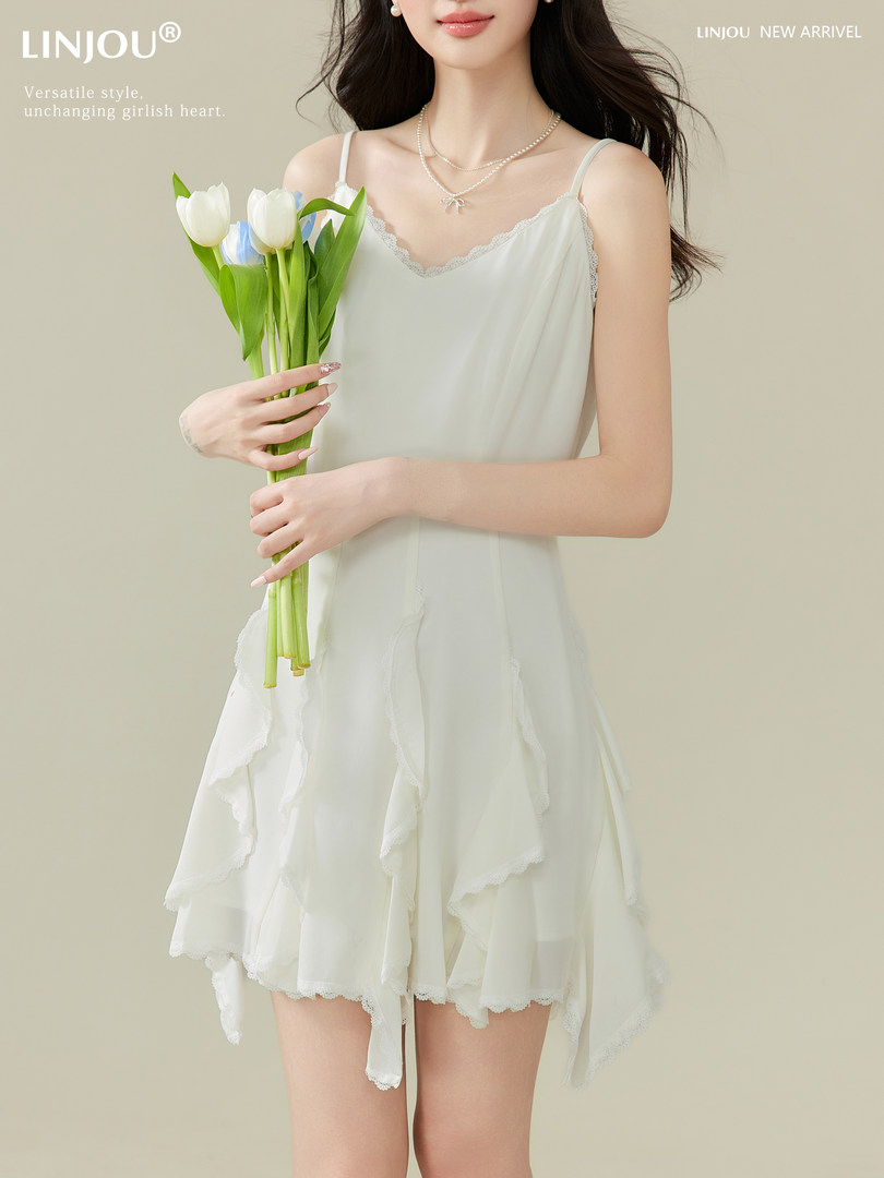 White sleeveless ruffled dress worn by a model holding flowers