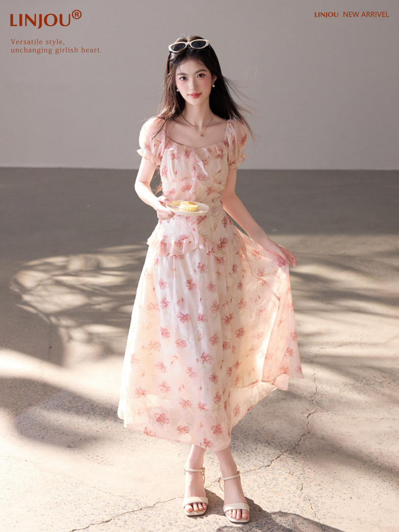 Model wearing a pink floral midi dress with short puff sleeves
