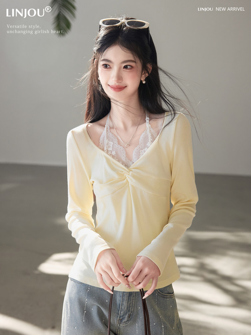 Model wearing a light yellow long-sleeve top with a lace camisole layered underneath