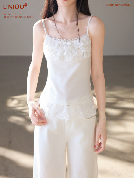White lace-trim camisole and matching lounge pants on a model