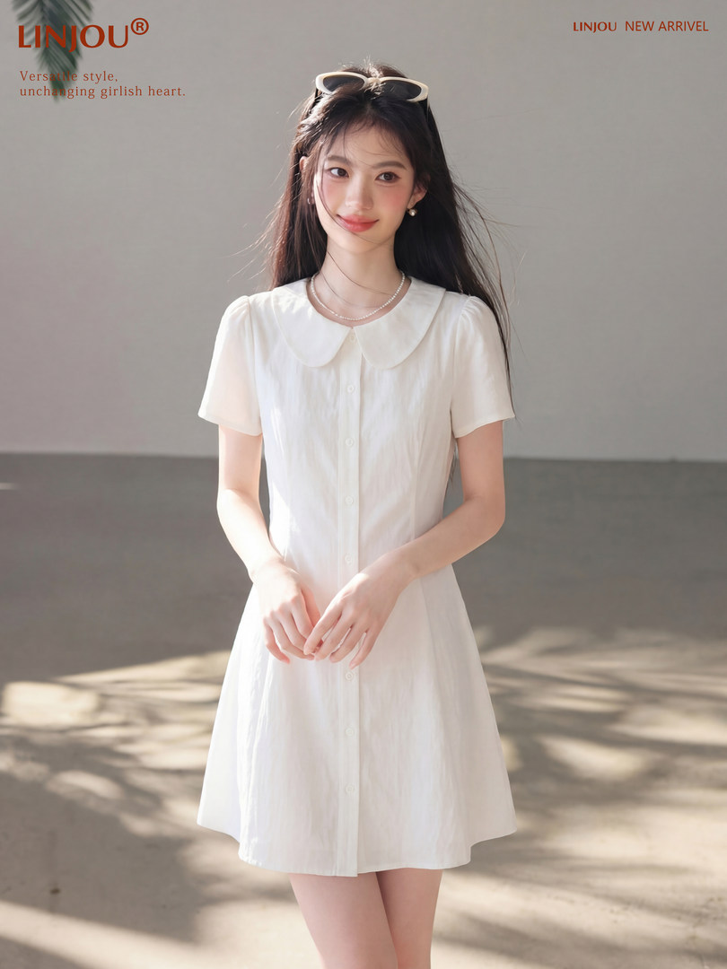 White short-sleeve button-front dress worn by a model