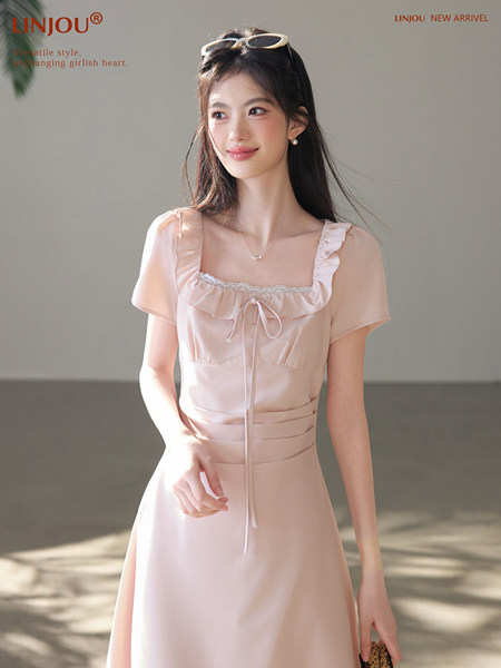Model wearing a light pink ruffled short-sleeve dress
