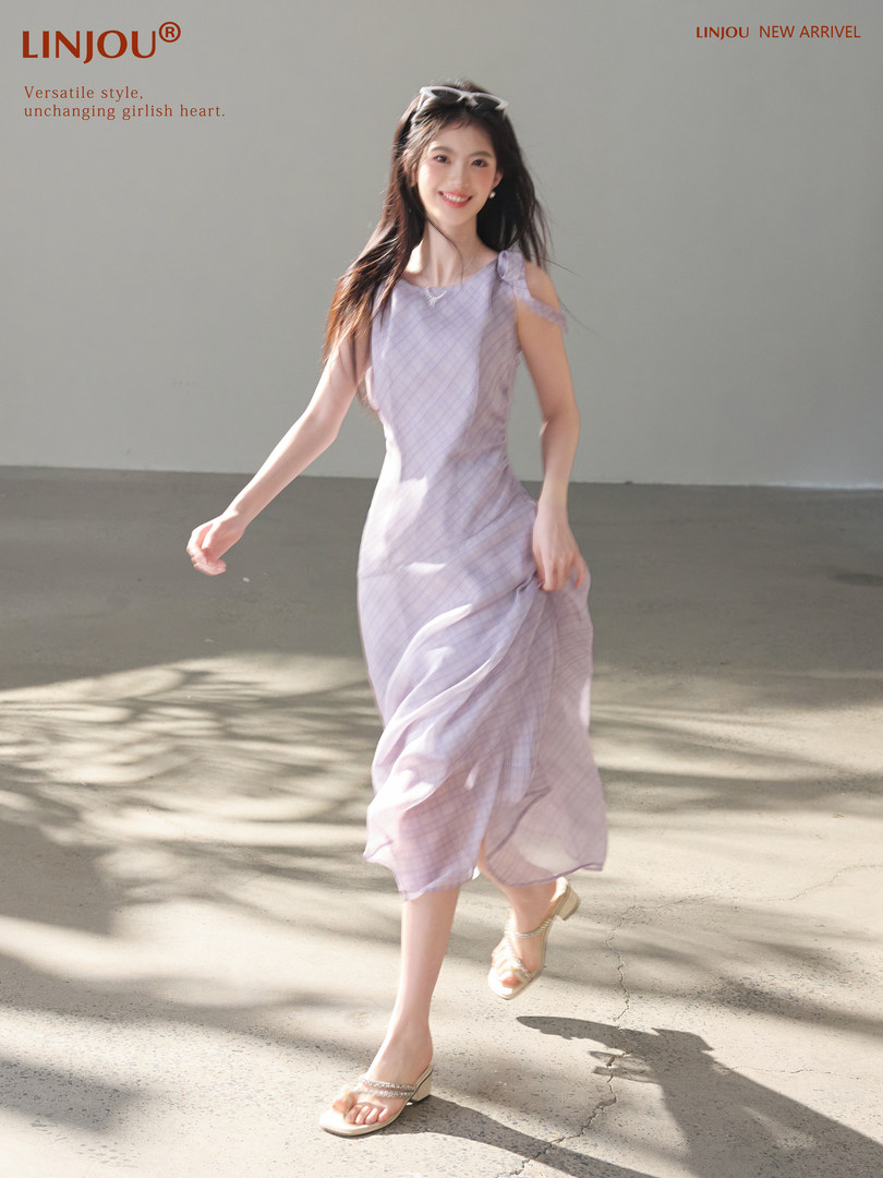 Model wearing a light purple sleeveless midi dress
