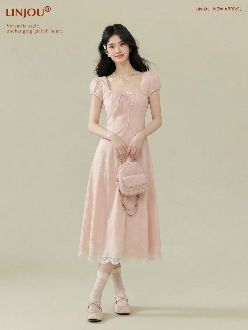 Pink short-sleeve midi dress worn by a model with a matching mini bag