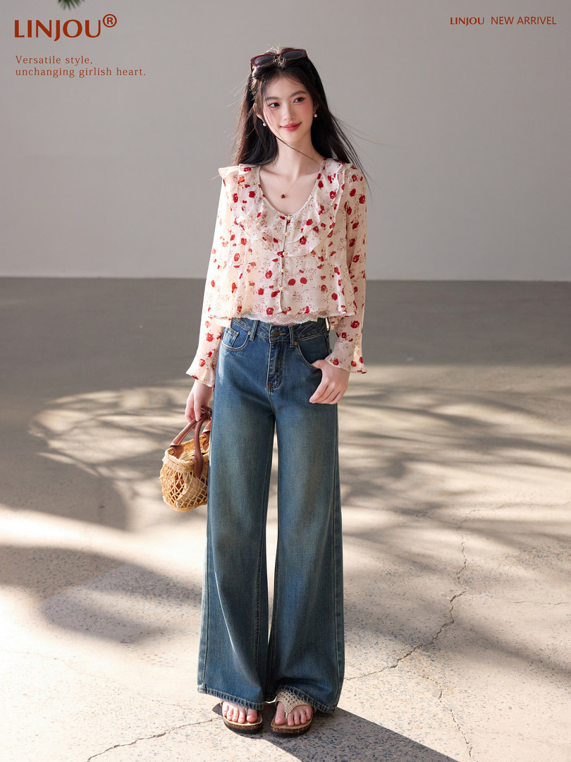 Model wearing a floral long-sleeve blouse with wide-leg jeans
